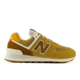 Championes New Balance 574 de mujer, en tonos mostaza y marrón, con entresuela ENCAP y el logotipo "N" en los laterales.