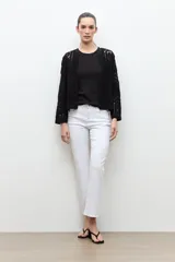 Chaqueta tejida a crochet en color beige claro, de diseño abierto y manga larga con patrones geométricos calados.
