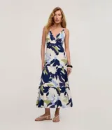 Vestido midi de viscolino con escote en V, breteles anchos y falda con recortes y fruncidos. Presenta un estampado de follaje en tonos azul, celeste y verde sobre base clara.