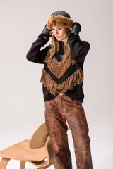 Gorro tipo ushanka de piel sintética en tono beige con textura suave y voluminosa.