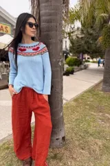 Sweater tejido color beige con cuello redondo y corazones rojos en el canesú.