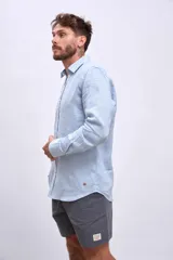 Camisa de lino color crudo, de corte recto, con cuello clásico y mangas largas.