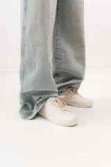 Championes de cuero color blanco con detalle de corona en animal print y talón verde. Cuentan con suela de caucho, lengüeta de gamuza y forro textil, con cierre mediante cordones al tono.