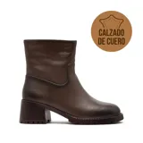 Bota de caña media confeccionada en cuero vacuno color marrón oscuro, con taco cuadrado robusto y suela track dentada.