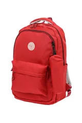 Mochila escolar de tela color azul claro, con múltiples compartimentos con cierre, bolsillo frontal con cierre y un pequeño accesorio colgante cilíndrico a juego. Presenta un parche circular con un emoji sonriente en el frente.