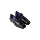 Zapatos tipo Mary Jane Eme Studios modelo Daisy, de color negro con acabado brillante y 100% piel auténtica. Presentan un diseño estructurado con puntera cuadrada, correa en T con hebilla metálica dorada y suela con la marca grabada en el lateral.