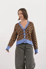Saco tipo cardigan con estampado animal print de leopardo, con cuello en V, cierre frontal de botones y detalles en color celeste en cuello, puños y ruedo.
