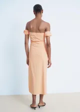Vestido midi color salmón, de corte entallado con diseño palabra de honor, mangas cortas caídas abullonadas y tajo lateral en la falda.