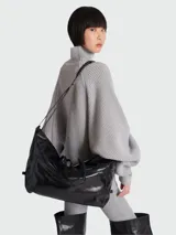 Bolso tote Balmain modelo Track Zip, confeccionado en cuero negro con acabado brillante. Presenta un diseño estructurado con cierre superior, doble asa de mano y correa de hombro ajustable y extraíble.