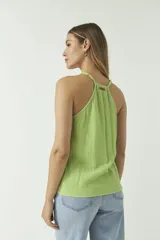 Musculosa verde manzana de algodón con textura arrugada, escote en V y cierre frontal con botones.
