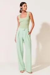 Pantalón de vestir verde menta, de corte palazzo, con cintura alta y pinzas frontales.