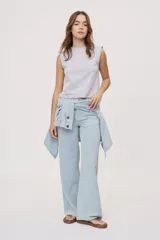 Pantalón wide leg de tiro medio con estampado de rayas verticales, diseño de cinco bolsillos, presillas para cinto y cierre frontal con botón y cremallera.