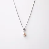 Conjunto compuesto por collar y anillo en plata 925, ambos con perla de río natural y engarce de circonia. El collar presenta una cadena fina con dije de perla colgante y el anillo destaca por su diseño minimalista con perla central.