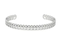 Esclava abierta de acero plateado con diseño de doble banda, una con textura de esferas pequeñas y otra con eslabones tipo cadena.