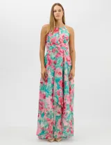 Vestido largo de chifón con estampado floral en tonos rosa y turquesa. Presenta cuello halter con abertura tipo lágrima, cintura drapeada con detalle de nudo central y falda amplia con capas asimétricas. Incluye forro interior y cierre invisible en la espalda.
