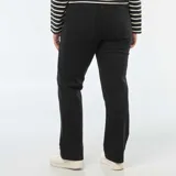 Pantalón negro de denim, corte flare, con bolsillos frontales tipo parche.