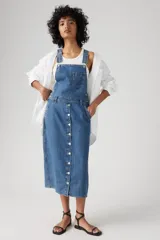 Vestido midi de jean azul con breteles, bolsillo en el pecho y falda recta con botones frontales.