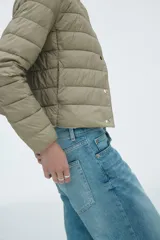 Campera acolchada de nylon con diseño guateado, cuello redondo y cierre frontal mediante botones a presión. Presenta bolsillos laterales discretos, puños con elástico fino y forro interior.