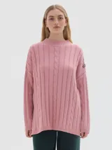 Buzo tejido de punto color beige, con cuello subido, diseño oversized y aberturas laterales en el ruedo.