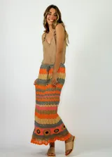 Pollera larga tejida a crochet con diseño de rayas horizontales en tonos naranja, fucsia y morado.