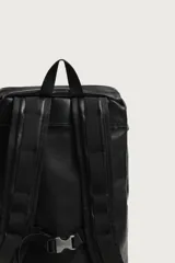 Mochila de piel negra de la colección especial Aaron Levine x Zara, con compartimento principal con solapa y hebilla, bolsillos exteriores en los laterales y asas ajustables.