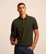 Remera polo de manga corta color verde militar, confeccionada en algodón peruano con cuello convencional y cierre de botones.