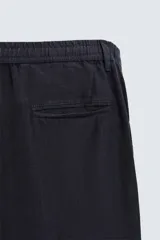 Pantalón de vestir azul marino confeccionado en tejido de lino. Corte recto, con bolsillos laterales y traseros. Se ajusta a la cintura con botón y cremallera.