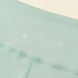 Legging deportivo de tiro alto con diseño de cintura cruzada en forma de V, confeccionado en tejido elástico de color verde menta.