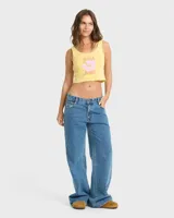Top musculosa Billabong de corte crop en color amarillo, con diseño estampado frontal de flor tropical y texto en tonos rosados y naranjas.