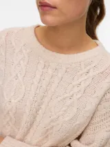 Sweater de punto color beige, con cuello redondo, mangas largas y diseño holgado con tejido de ochos.
