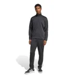 Conjunto deportivo Adidas M Lin Ts de color negro, compuesto por una campera con cierre frontal y cuello alto, y un pantalón largo tipo jogging. Cuenta con detalle de la marca en la manga.