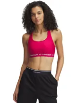 Top deportivo de soporte medio Under Armour, color fucsia con banda elástica inferior con logo de la marca. Presenta diseño de espalda cruzada y tejido HeatGear de secado rápido.