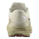 Championes Salomon DRX Defy Grvl de running y trail, en color beige y tostado, diseñados con tejido de malla transpirable, tecnología Active Chassis y suela con tacos para mayor tracción en superficies mixtas.