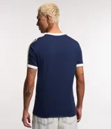 Remera regular verde oscuro de algodón, con cuello redondo, manga corta y detalles de rayas dobles en los hombros y terminaciones en color blanco.