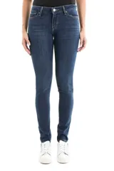Jean de corte skinny y tiro medio, confeccionado en denim de tono azul oscuro con acabado uniforme. Presenta cierre frontal con botón y cremallera, además de bolsillos laterales y traseros clásicos.