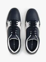 Zapatillas de tenis Tommy Hilfiger de corte bajo, confeccionadas en piel napa color azul marino con paneles laterales en contraste color blanco. Presentan cierre con cordones, suela de goma blanca y logo de la marca grabado en el lateral y el talón.