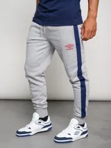 Pantalón de jogging azul marino de felpa con corte ajustado y banda lateral gris.