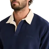 Buzo tipo polo de polar color azul marino, con cuello camisero en color crema y puños elásticos.