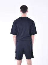 Bermuda negra de tejido texturizado con cintura elástica ajustable con cordón y bolsillo lateral tipo cargo.