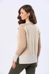 Buzo tejido de punto con diseño de bloques de color en tonos rosa, beige y gris. Presenta cuello redondo, mangas largas y puños acanalados.