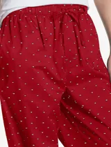 Pantalón de pijama rojo con estampado de logos de Tommy Hilfiger en blanco.