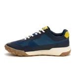 Championes Caterpillar modelo Hex Ready T-Toe para hombre, en color azul marino con detalles en amarillo, blanco y suela de goma marrón. Capellada combinada de cuero, paneles textiles y refuerzos sintéticos, con entresuela de EVA y cordones blancos.
