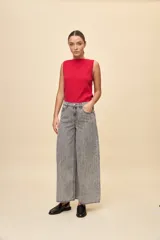 Jean wide leg de tiro alto color celeste, con calce amplio y pierna ancha, diseño de cinco bolsillos y cierre frontal con botón y cremallera.