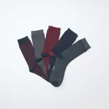 Pack de cinco pares de medias de algodón con diversos diseños, incluyendo rayas horizontales, lisas y con pequeños puntos.