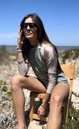 Remera de lycra verde con mangas ranglan color beige, de calce ajustado y protección UV.