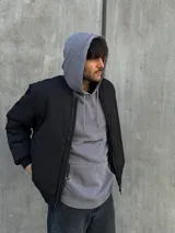 Campera puffer negra de nylon con cierre frontal y cuello alto.