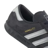 Championes Adidas Hamburg de gamuza color azul marino con las tres tiras plateadas y detalles en dorado.