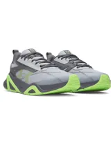 Championes de entrenamiento Under Armour Charged Commit TR 5, color gris con detalles en verde neón. Presentan parte superior de malla transpirable con revestimientos de cuero, entresuela Charged Cushioning para absorción de impactos y suela de goma con refuerzos laterales.