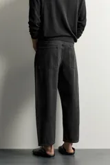 Jeans tapered wide fit de hombre, confeccionados en denim de algodón con efecto lavado en tono azul oscuro. Presentan diseño de cinco bolsillos, tiro medio, corte relajado y cierre frontal con cremallera y botón.