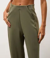 Pantalón de corte recto confeccionado en tejido de modal con mezcla de poliéster y elastano. Presenta un diseño minimalista con cintura elástica y costuras verticales que aportan estructura a la prenda.